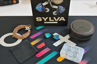 Sylva earbud packaging with accessories on a colorful background